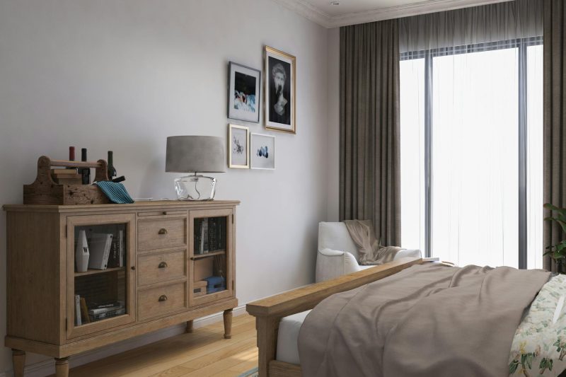 Stylish bedroom with wooden cabinet, cozy decor, and ample natural light.